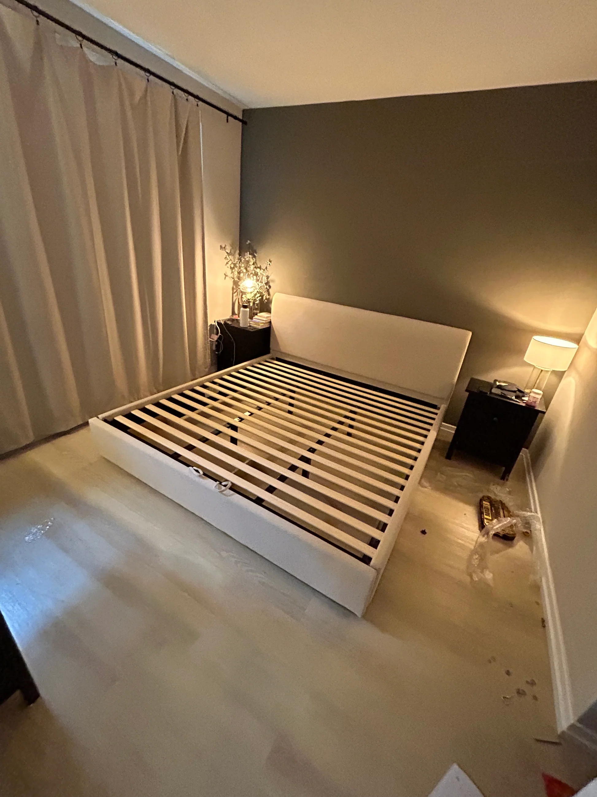 A bedroom with a bed and a lamp