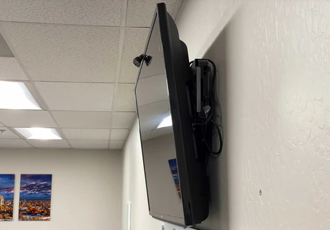 A television mounted to the side of a wall