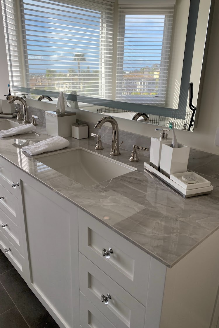 A bathroom with two sinks and a large mirror